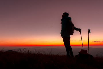 23.10.2019 Friend Group hiking Doi Monjong, Chiang Mai, Thailand., Silhouette Hiking people reaching summit giving at mountain top at sunset. Photo with high shadow and selective focus.