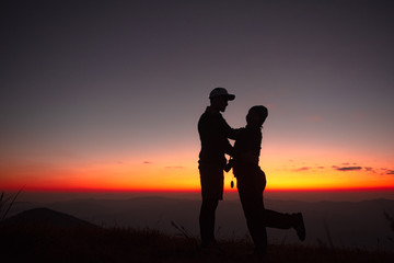 Fototapeta na wymiar 23.10.2019 Friend Group hiking Doi Monjong, Chiang Mai, Thailand., Sunset Silhouette of Young Lovers Hugging in the Mountains., Photos with high shadows and selectable focus