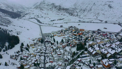 Fototapeta na wymiar Flight over the famous village of Andermatt in Switzerland in winter - aerial photography