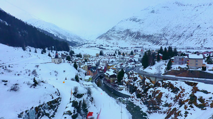 Flight over snow-capped mountains in the Swiss Alps on a winter's day - aerial photography