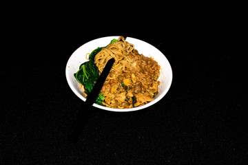 Indonesian traditional chicken noodles with black background.