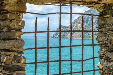 An old window with fantastic mountain sea view in Malcesine, Italy.