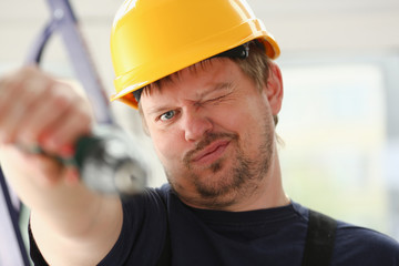 Arms of worker using electric drill closeup. Manual job DIY inspiration improvement fix shop yellow helmet joinery startup idea industrial education profession career concept