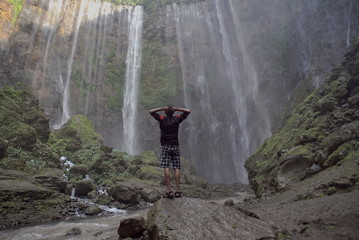 traveller in in the waterfall