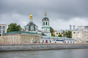 Fototapeta na wymiar Russian orthodox Church at the riverbank of the Moskva River, Moscow, Russia. View form a cruise ship on the river.