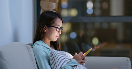 Woman work on cellphone at home