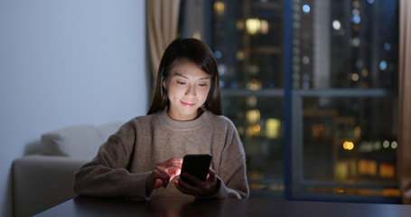 Woman look at mobile phone at night