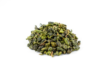 Pile of dry green tea oolong leaves on a white background close-up.
