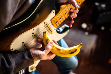 Going bananas concept. Playing guitar with a banana.