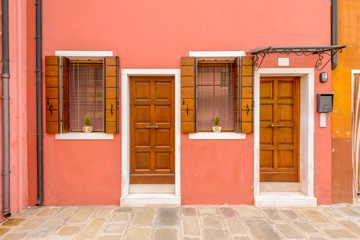 Entrance of a colorful apartment building in Burano, Venice, Italy.