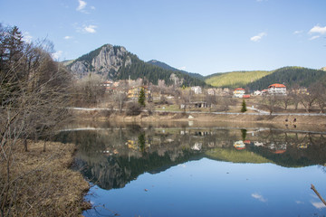 Obraz premium Mountain landscape, beautiful blue sky and white clouds, lake and trees reflection in the water, forest scenery, Smolyan, Bulgaria