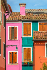 Colorful apartment building with nice waterfront view in Burano, Venice, Italy.