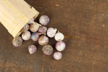 Small solo single clove garlic monobulb garlic single bulb garlic pearl garlic rustic wood background