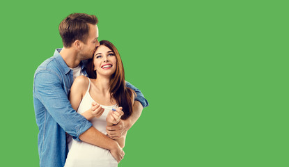 Love, new parents and family concept - very happy excited couple, finding out results of a pregnancy test. Green background. Copy space for some text.