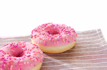 Donuts with pink icing and marshmellow. unhealthy food concept. dougnuts on thr table