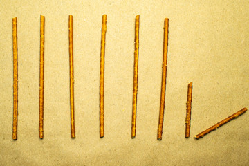 Pretzel sticks in zigzag pairs on a beige background
