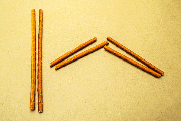 Pretzel sticks in zigzag pairs on a beige background1