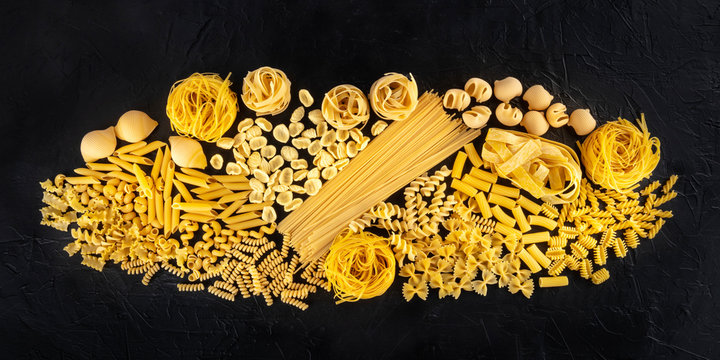 Italian pasta panorama, a flat lay of a variety of pasta kinds, overhead shot on a black background