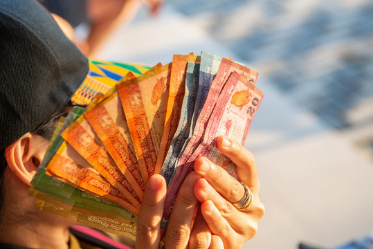 Cropped shot of woman hand holding a group of Sri Lanka banknotes in her hand. Sri Lankan rupee is the currency of Sri Lanka "LKR" is occasionally used to distinguish it.