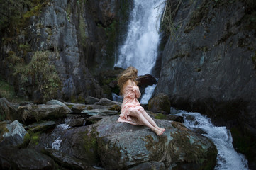 Fototapeta na wymiar Girl on the background of a waterfall