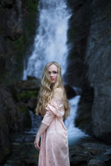 Fototapeta premium Girl on the background of a waterfall