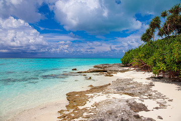 Turquoise blue sea water shore and cloudy sky
