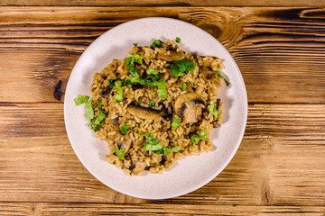 Risotto with mushrooms and paesley in a plate. Top view
