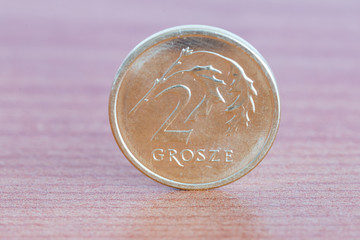 Polish 2 grosze coin on wooden table. - obrazy, fototapety, plakaty