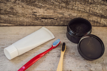 Activated charcoal powder VS plastic brush and toothpaste for brushing and whitening teeth. Bamboo...