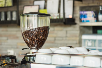 Fresh Coffee Beans on a coffee machine in a cafe, Selective focus.