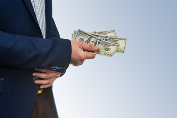 Successful businessman holding american dollar cash money isolated on white background.
