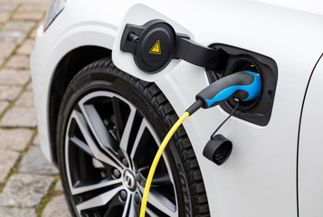 Fototapeta na wymiar Charging of electric car in the city
