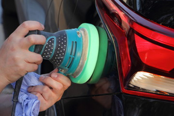 Mechanical polishing of the car body with a sanding machine, repair of minor damages