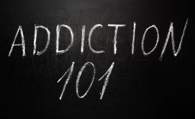 Addiction 101 written in white chalk on a black chalkboard