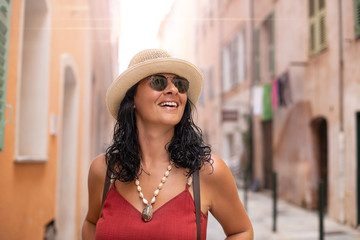 Tourist woman is walking at the narrow streets of Corsica