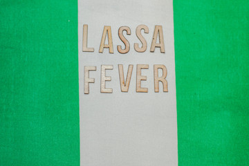 Nigerian flag under words Lassa fever outbreak concept. protective breathing mask and syringe. Lassa hemorrhagic fever LHF endemic in West Africa including Sierra Leone, Liberia, Guinea and Nigeria