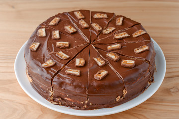 Delicious salted caramel chocolate cake with nuts and vanilla decorated with chocolate pieces