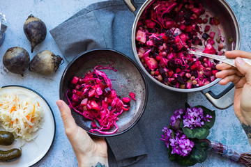 Vinaigrette, vinegret or beetroot Ukrainian, Russian traditional salad with cooked and pickled vegetables. Put vinaigrette in bowl with spoon.