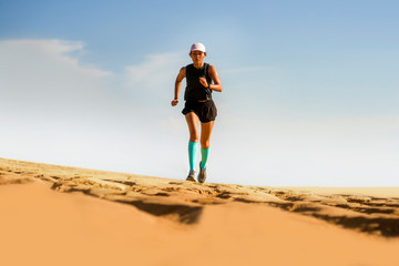 outdoors fitness lifestyle portrait of young attractive and athletic Asian woman in compression running socks on the beach doing jogging workout in sport training