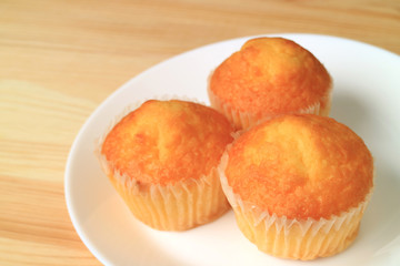 Plate of Madeleine Cupcakes Served on Wooden Table