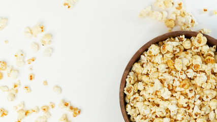 photo sweet popcorn on a white background wooden bowl top view