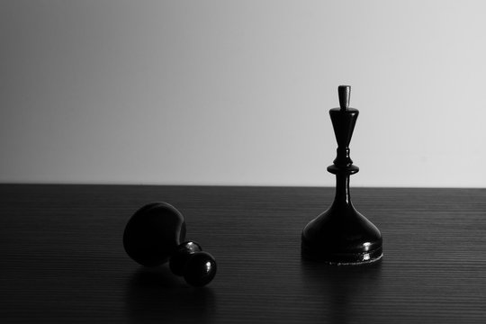 Chessmen. Black and white photo. King and pawn.