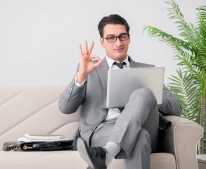 Businessman with laptop notebook sitting in sofa