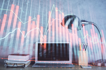 Double exposure of graph and financial info and work space with computer background. Concept of...