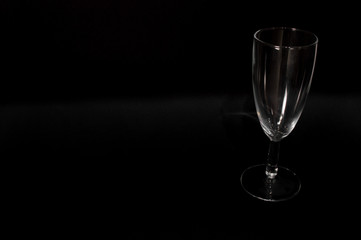 Empty сhampagne glass on black background