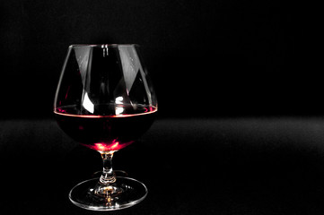 Glass of dark red brandy,   whiskey or bourbon