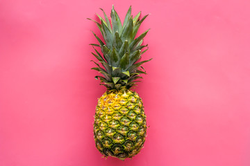 Pineapple - whole fruit - on bright pink background top-down copy space