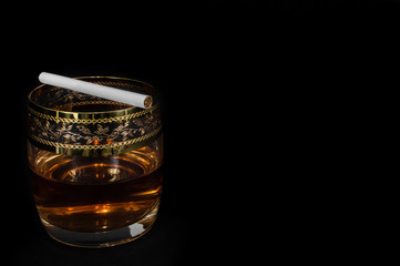 Glass of dark red whiskey, brandy or .bourbon