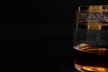 Glass of dark red whiskey, brandy or .bourbon