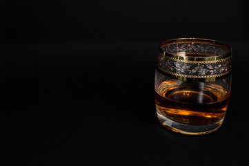 Glass of dark red whiskey, brandy or .bourbon